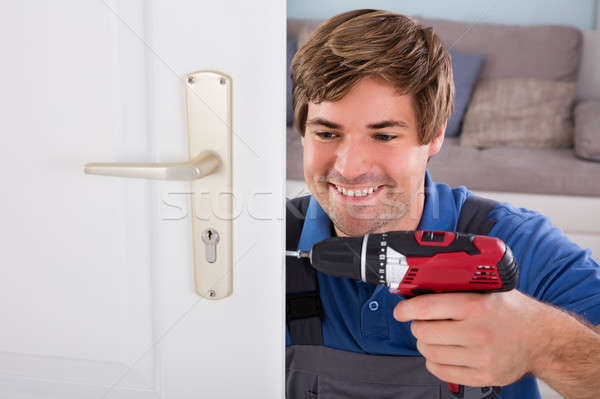 Stock photo: Carpenter Installing Door Lock