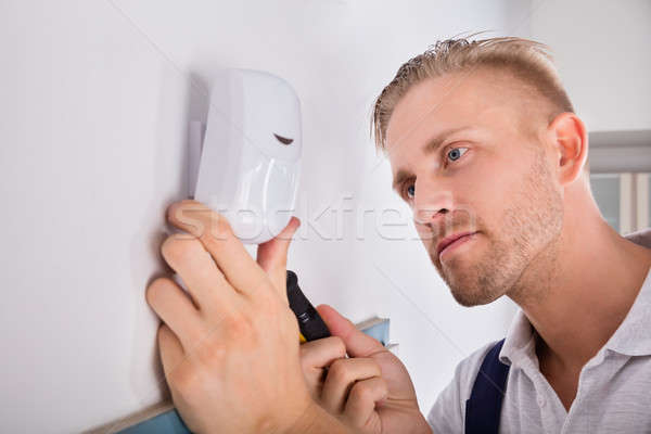 Man Installing Motion Detector For Security System Stock photo © AndreyPopov