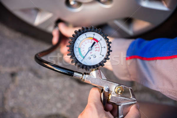 Person Measuring Car Tyre Pressure Stock photo © AndreyPopov