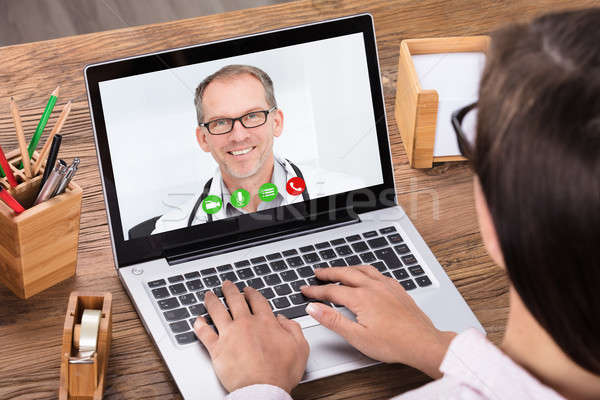 Woman Doing Video Chatting With A Male Doctor Stock photo © AndreyPopov