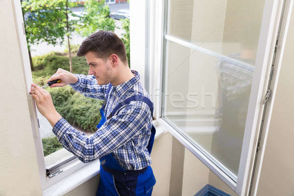 Handyman Fixing Window With Screwdriver Stock photo © AndreyPopov