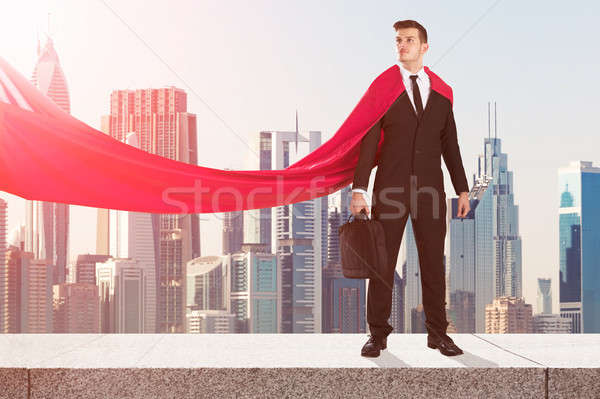 Stock photo: Superhero Businessman With Buildings In Background