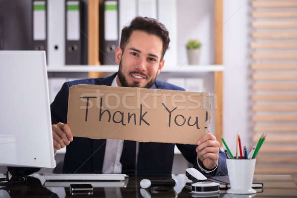 Businessman Holding Cardboard With Thank You Text Stock photo © AndreyPopov
