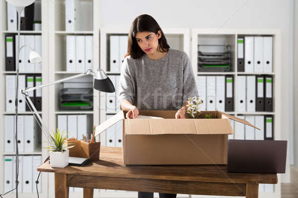 Businesswoman Packing Her Belongings In Cardboard Box Stock photo © AndreyPopov