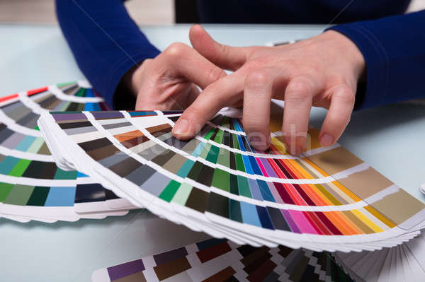 Stock photo: Designer Choosing Color From Color Swatches