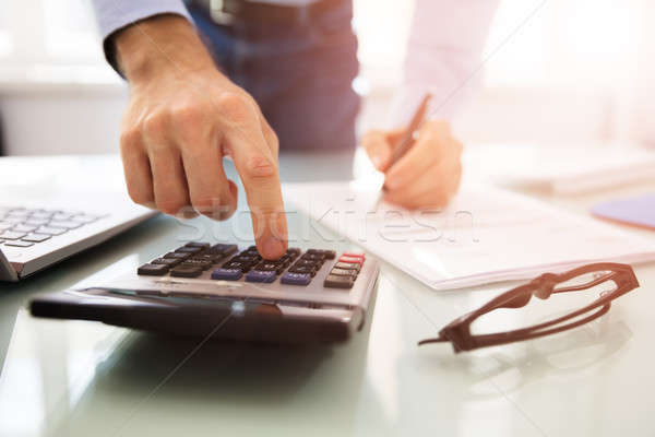 Stock photo: Businessperson Using Calculator