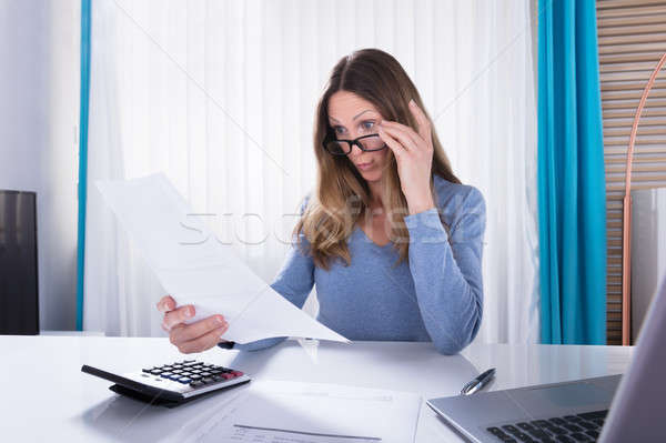 Shocked Woman Looking At Document In Office Stock photo © AndreyPopov