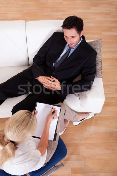 Férfi beszél pszichiáter kilátás üzletember kanapé Stock fotó © AndreyPopov