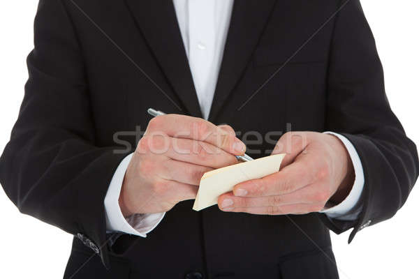 Midsection Of Waiter Writing On Notepad Stock photo © AndreyPopov