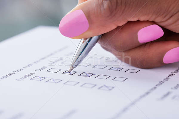 Businesswoman's hand filling customer survey form Stock photo © AndreyPopov