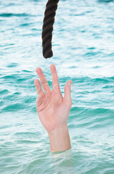 Drowning Man Reaching For Rope Stock photo © AndreyPopov