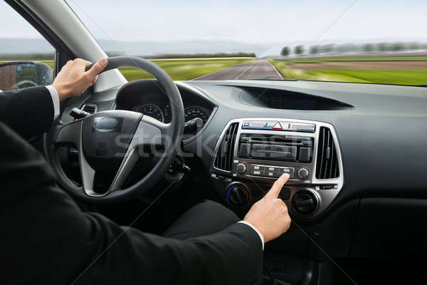 Businessman Pressing Button On Dashboard Stock photo © AndreyPopov