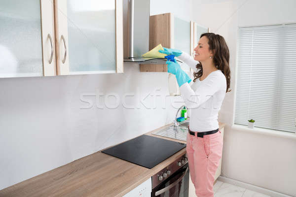 Woman Cleaning Cooker Hood Stock photo © AndreyPopov