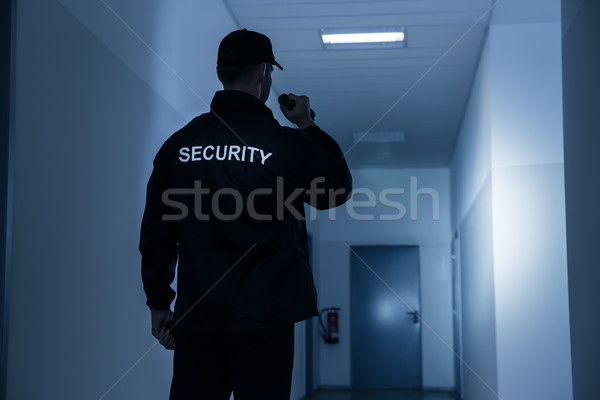Security Guard With Flashlight In Building Corridor Stock photo © AndreyPopov