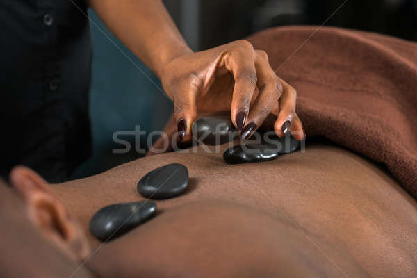 Férfi forró kő terápia közelkép afrikai Stock fotó © AndreyPopov