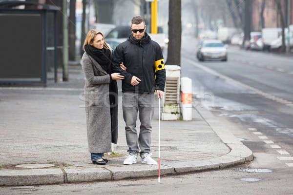 Woman Assisting Blind Man On Street Stock photo © AndreyPopov