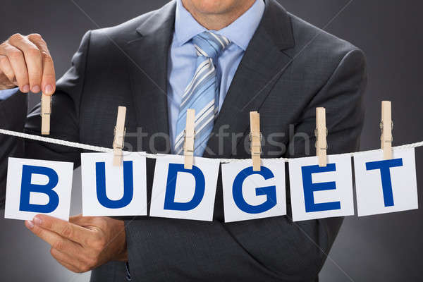 Businessman Pinning BUDGET Cards On Clothesline Stock photo © AndreyPopov