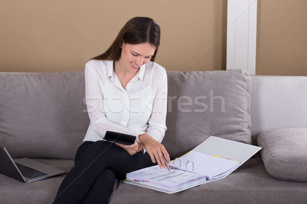 Happy Woman Calculating Finance Stock photo © AndreyPopov