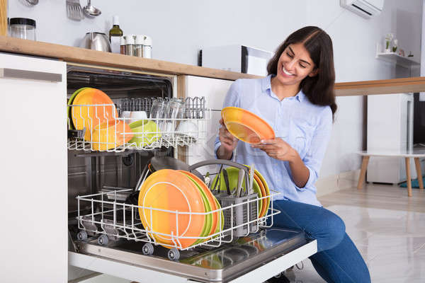 Woman Arranging Plates In Dishwasher Stock photo © AndreyPopov