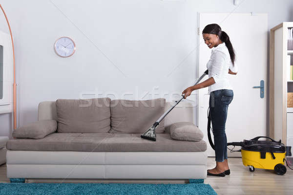 African Woman Cleaning Sofa With Vacuum Cleaner Stock Photo Andreypopov 8637191 Stockfresh - How To Clean Sofa Using Vacuum Cleaner African Woman Cleaning Sofa With Vacuum Cleaner Stock Photo Andreypopov 8637191 Stockfresh - How To Clean Sofa Using Vacuum Cleaner