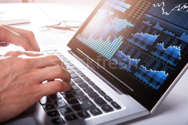 Businessman Analyzing Graph On Laptop Stock photo © AndreyPopov