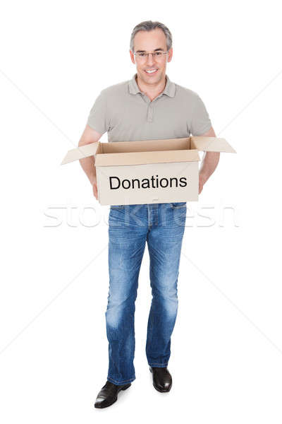 Stock photo: Happy man holding donation box