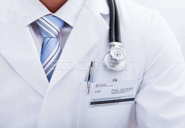 Pocket on a lab coat with a doctors ID tag and pen Stock photo © AndreyPopov