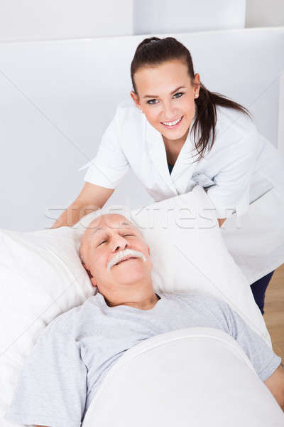 Happy Doctor With Senior Man Lying In Bed Stock photo © AndreyPopov