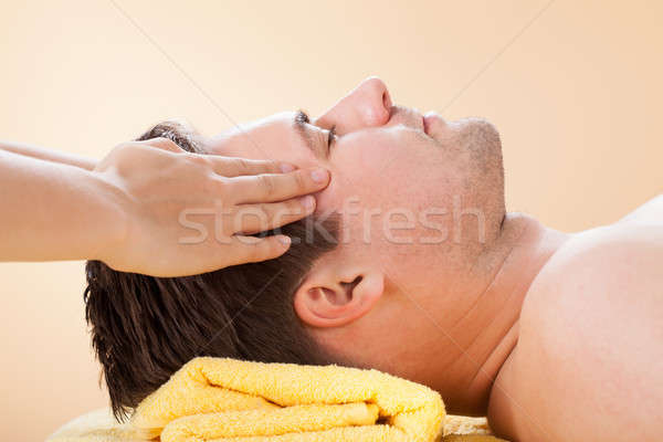 Człowiek czoło masażu spa widok z boku młody człowiek Zdjęcia stock © AndreyPopov