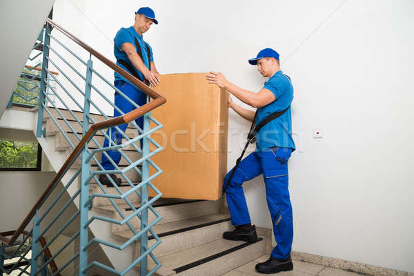 Two Movers Standing With Box On Staircase Stock photo © AndreyPopov