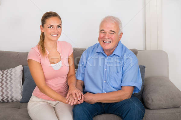 Woman Sitting On Sofa Holding Her Father's Hand Stock photo © AndreyPopov