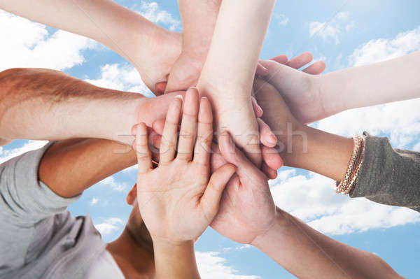 Stacking Hands Against Sky Stock photo © AndreyPopov