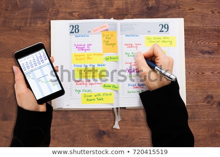 Businessperson Looking At List Of Schedule In Diary stock photo ...