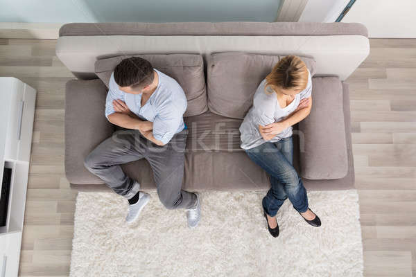 Upset Couple Sitting On Couch Stock photo © AndreyPopov