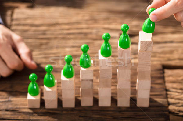 Businessman Arranging The Figures On Block Stack Stock photo © AndreyPopov