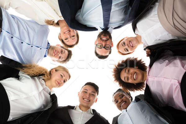 Happy Businesspeople Forming Huddle Stock photo © AndreyPopov