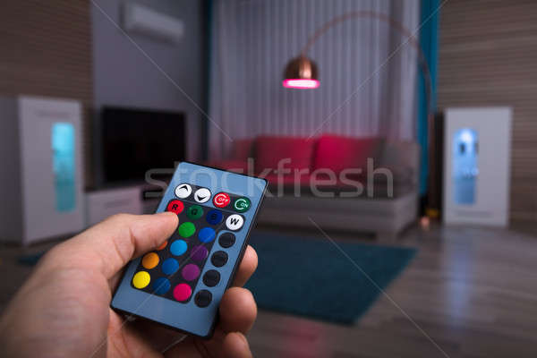 Human Hand Adjusting Electric Light With Remote Control Stock photo © AndreyPopov