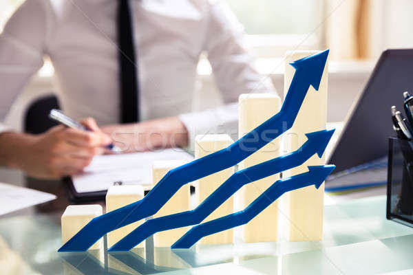 Blue Arrows In Front Of Graph Showing Upward Direction Stock photo © AndreyPopov