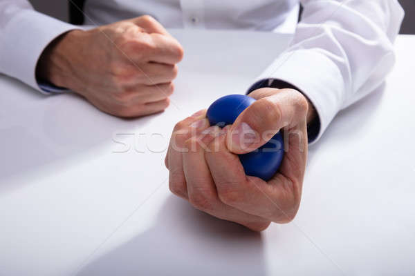 Businessman Pressing Stress Ball Stock photo © AndreyPopov