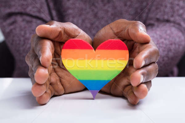 Man's Hand Protecting Colorful Heart Stock photo © AndreyPopov