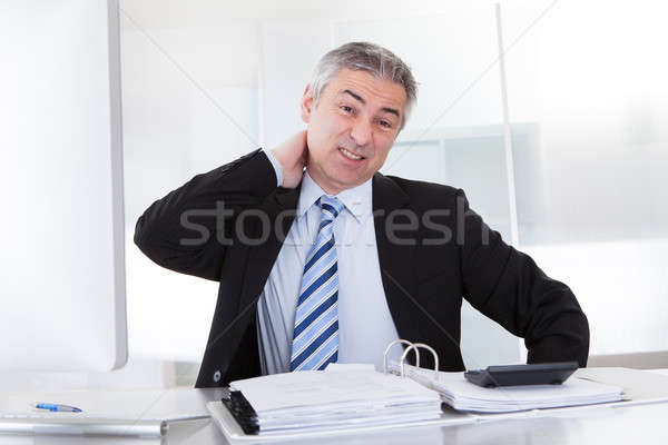 Mature Businessman With Neck Pain Stock photo © AndreyPopov