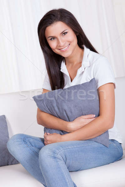 Nyugodt nő ül kanapé mosolyog kamera Stock fotó © AndreyPopov