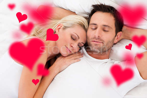 Loving Young Couple Sleeping In Bed Stock photo © AndreyPopov