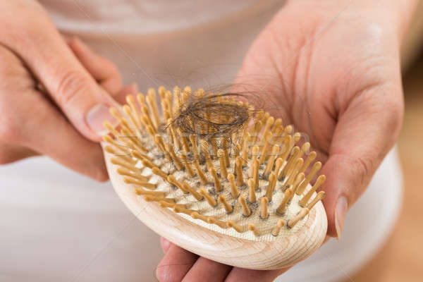 Person Hand Holding Comb With Loss Hair Stock photo © AndreyPopov