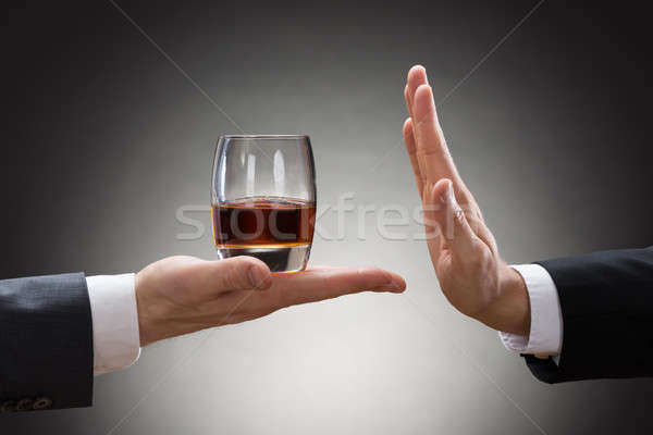 Businessman Rejecting Whisky Offered By Businessperson Stock photo © AndreyPopov