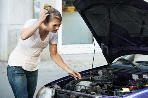 Confused Woman Looking At Broken Down Car Engine Stock photo © AndreyPopov