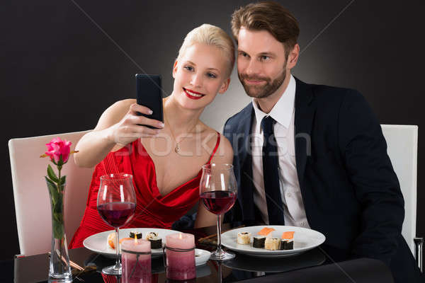 Young Couple Taking Selfie With Their Smartphone Stock photo © AndreyPopov