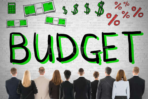Emberek néz költségvetés szó fal üzlet Stock fotó © AndreyPopov