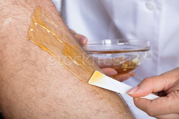 Beautician Waxing Man's Leg Stock photo © AndreyPopov