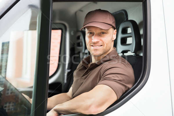 Happy Delivery Man Sitting Inside Van Stock photo © AndreyPopov